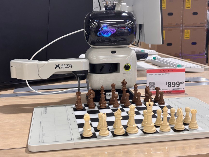 A robot playing chess with a physical chess board.